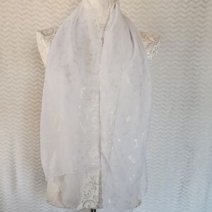 Elegant White Sheer Scarf with a gold musical note design.
